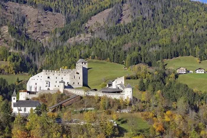 Framed Print : Medieval castle over autumnal forests and meadows in a sunny mountain landscape