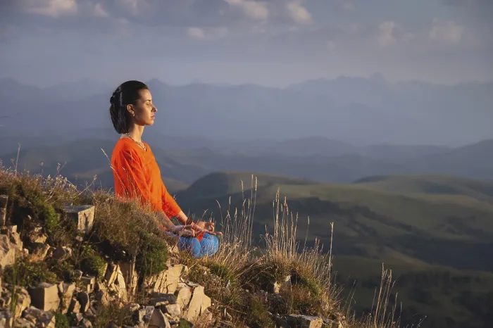 Framed Print : Meditating woman with closed eyes in bright clothes in the mountains