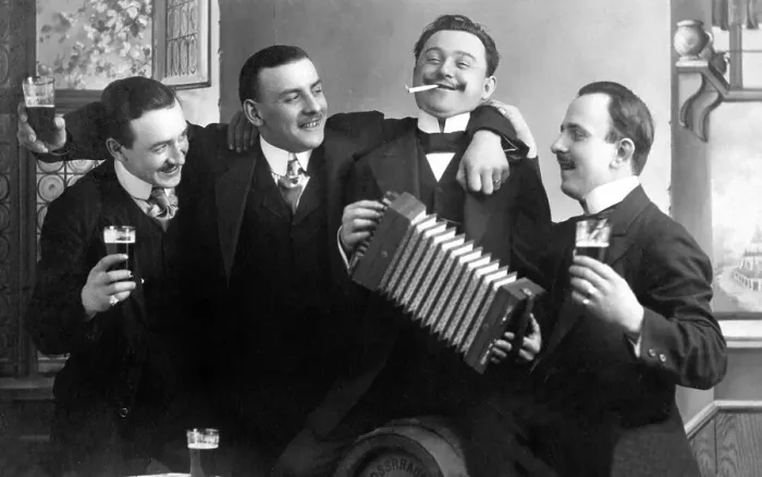 Framed Print : Men drinking beer and playing the accordion on a birthday party