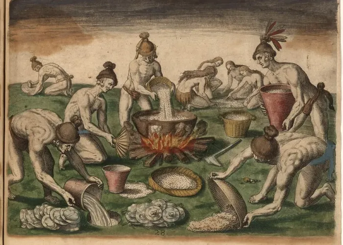 Framed Print : Men pour grain into a pot on the fire while woman sort food on the floor. Plates lie to be washed next to a hole where water has been placed. A man grinds herbs on a stone in the background Framed Print : Men pour grain into a pot on the fire while woman sort food on the floor. Plates lie to be washed next to a hole where water has been placed. A man grinds herbs on a stone in the background