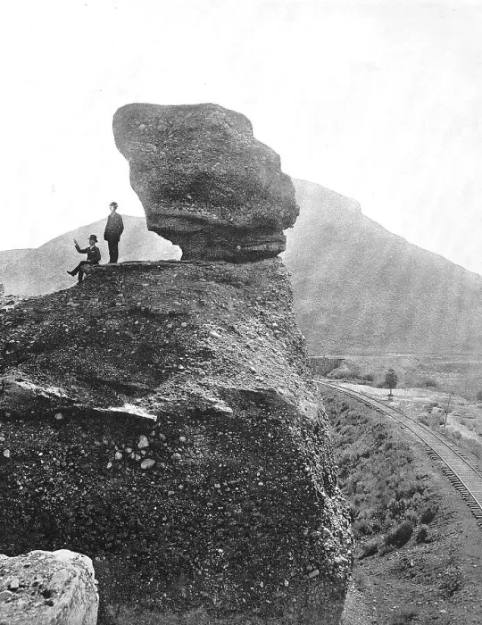 Framed Print : Men next to the rock formation