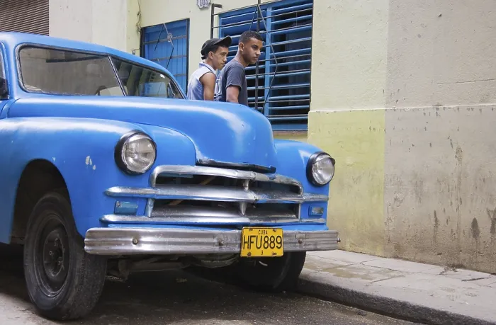 Framed Print : Two men standing behind a classic car