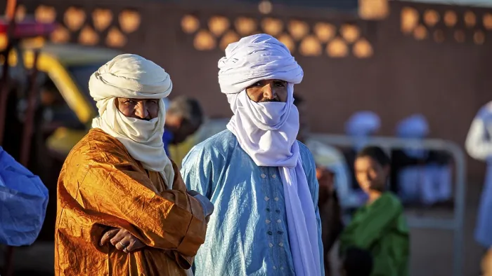 Framed Print : Two men in traditional dress with turbans stand outside