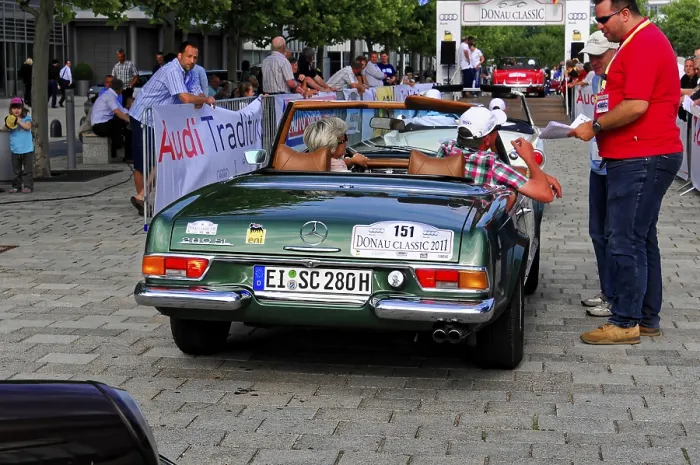 Framed Print : Mercedes Benz 280 SL, green Mercedes classic car at an outdoor event with people wearing summer clothes