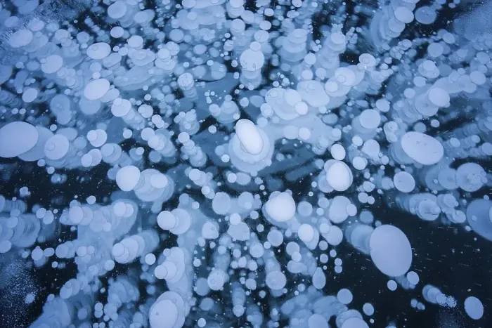 Framed Print : A mesmerizing view of numerous frozen bubbles captured in a thick layer of ice on a lake Framed Print : A mesmerizing view of numerous frozen bubbles captured in a thick layer of ice on a lake