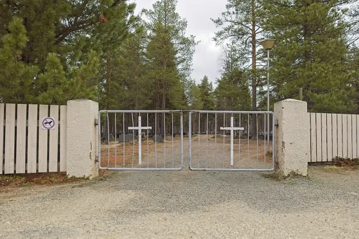 Framed Print : Metal cemetery gates with a cross in cloudy spring weather