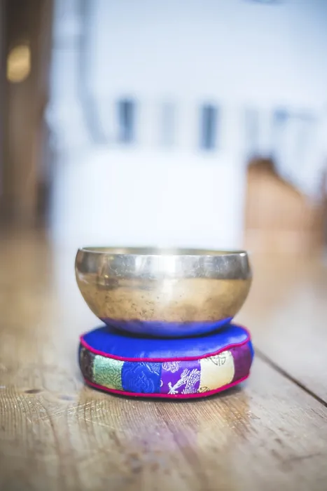 Framed Print : Metal singing bowl on a rustic wooden floor