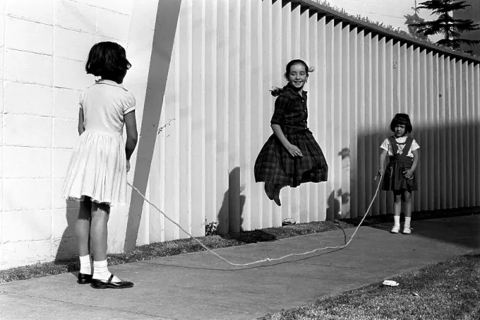 Framed Print : Mexico in the 1960s. Three girls are playing in the street
