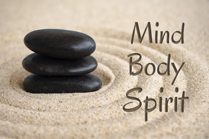 Framed Print : Mind, body and spirit text with black Zen stones on sand background