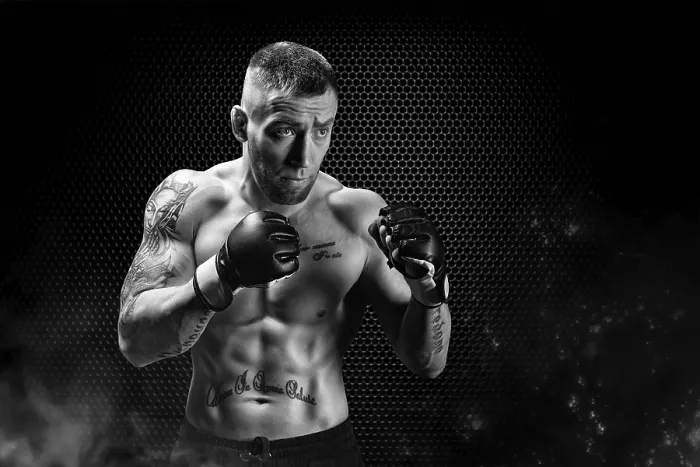 Framed Print : Mixed Martial Arts fighter posing on a metal grid background