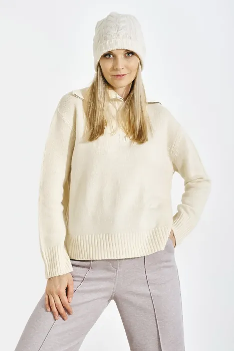 Framed Print : A model stands confidently in a studio while wearing a light sweater and a knitted hat Framed Print : A model stands confidently in a studio while wearing a light sweater and a knitted hat