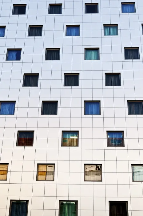 Framed Print : Modern building facade with a grid of square windows in various colors Framed Print : Modern building facade with a grid of square windows in various colors
