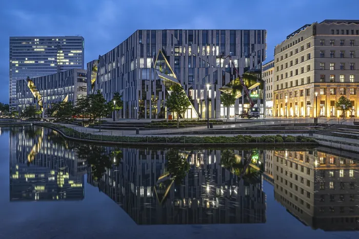 Framed Print : Modern buildings reflected in the water under a blue evening sky Framed Print : Modern buildings reflected in the water under a blue evening sky