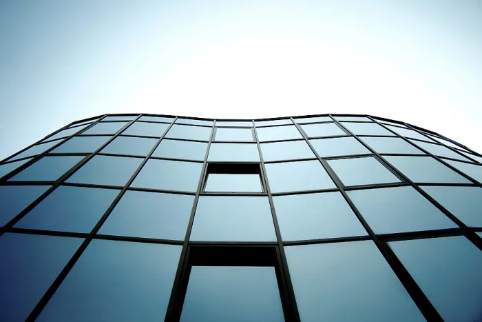 Framed Print : Modern glass building with blue sky reflection creating a geometric urban aesthetic Framed Print : Modern glass building with blue sky reflection creating a geometric urban aesthetic
