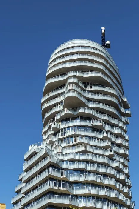 Framed Print : Modern glass facade with curved balconies on high-rise building