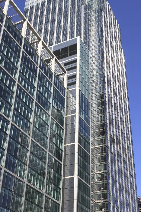 Framed Print : Modern glass skyscraper on a blue sky background Framed Print : Modern glass skyscraper on a blue sky background
