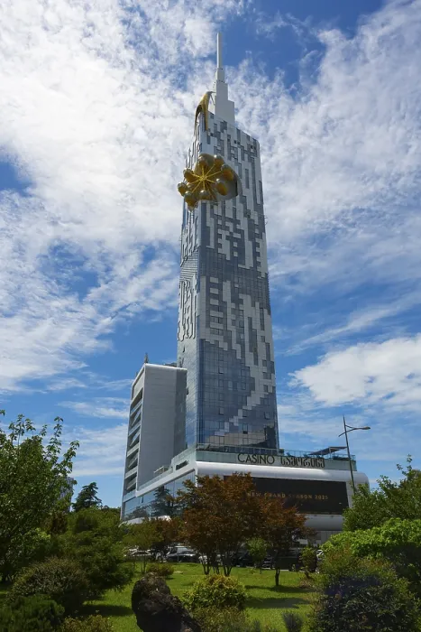 Framed Print : A modern high-rise building rises against a blue sky with clouds Framed Print : A modern high-rise building rises against a blue sky with clouds