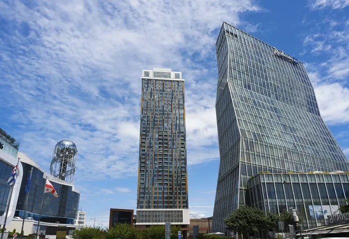 Framed Print : Two modern high-rise buildings with glass facades under cloudy sky Framed Print : Two modern high-rise buildings with glass facades under cloudy sky