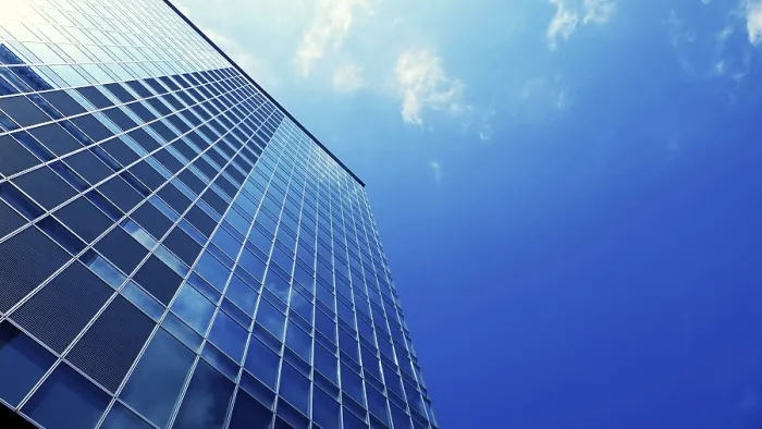 Framed Print : Modern office skyscraper building with blue sky background