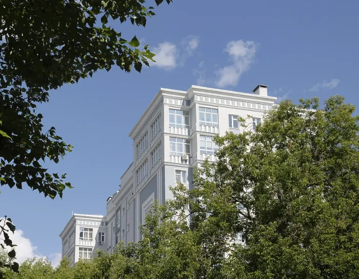 Framed Print : Modern residential building surrounded by green trees