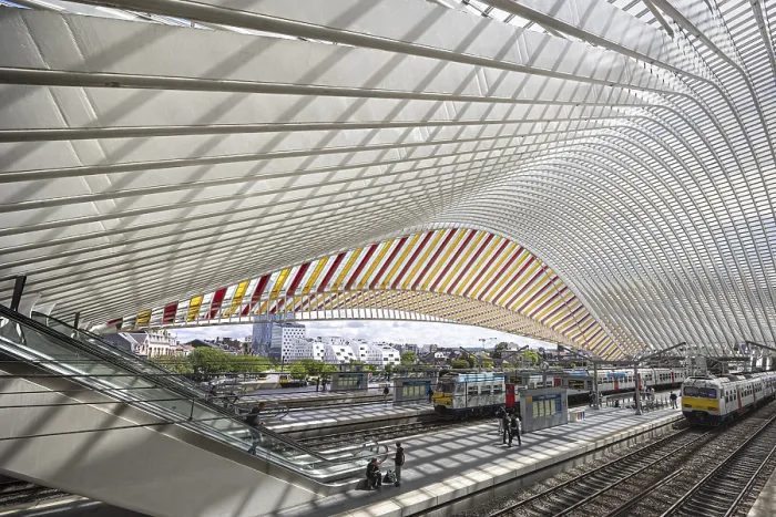 Framed Print : Modern station concourse with curved glass roof and visible train tracks