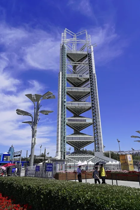 Framed Print : Modern tower under blue sky with light clouds and urban environment