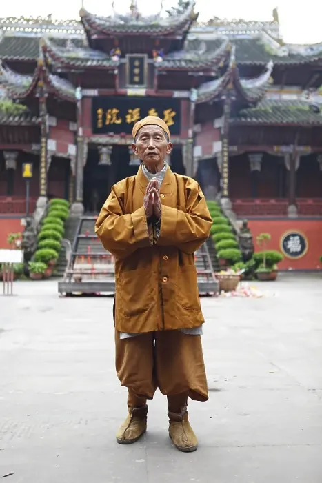 Framed Print : Monk, 85 years old, in front of Buddhist temple
