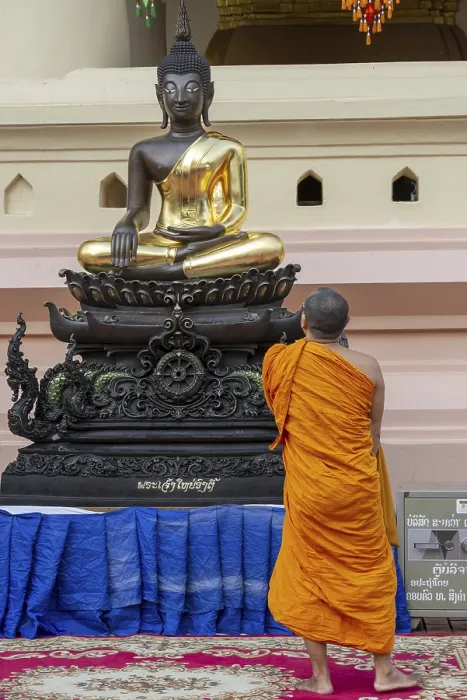 Framed Print : Monk in front of a Buddha statue Framed Print : Monk in front of a Buddha statue