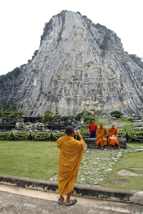 Framed Print : Monks taking a photograph of a Buddha image on a cliff