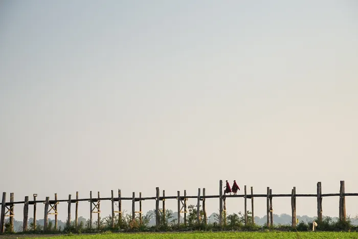 Framed Print : Monks walking on a teak bridge