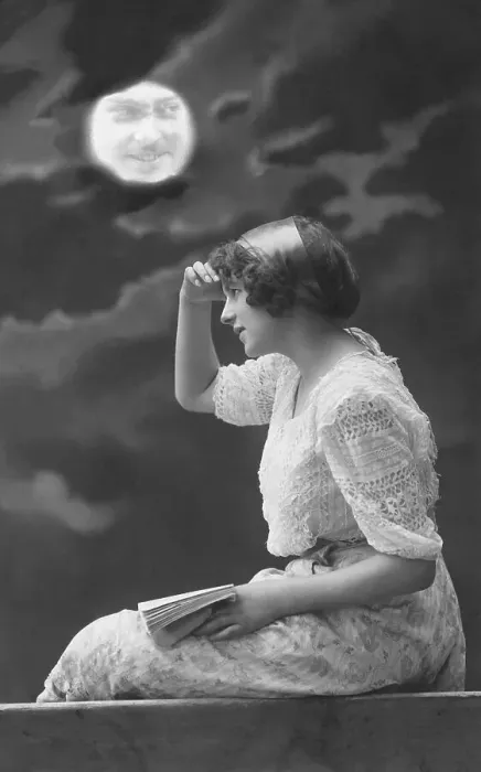 Framed Print : Full moon with face of a man, woman with book