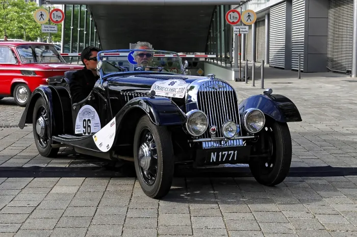 Framed Print : Morgan 4-4-2 Seater, black vintage convertible with two drivers on a paved road during a race Framed Print : Morgan 4-4-2 Seater, black vintage convertible with two drivers on a paved road during a race