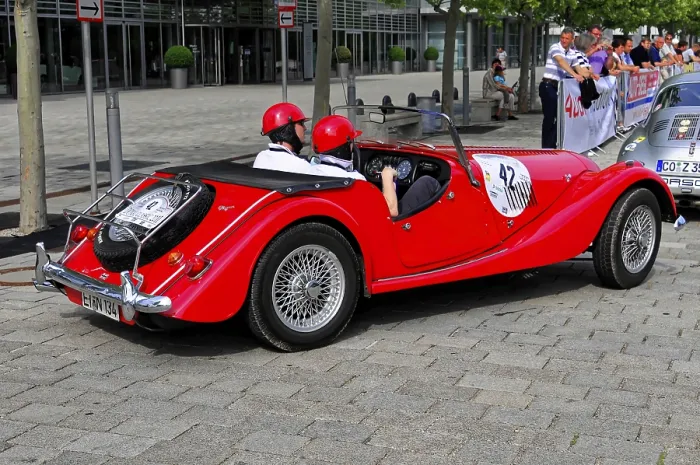 Framed Print : Morgan 4-4 Completition, red vintage convertible with helmet wearers in a city at a rally Framed Print : Morgan 4-4 Completition, red vintage convertible with helmet wearers in a city at a rally