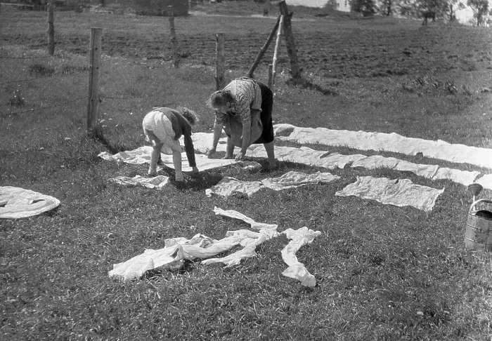 Framed Print : Mother and child put the laundry on the lawn and in the sun