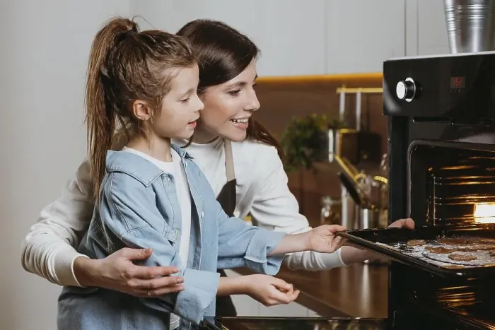 Framed Print : Mother daughter baking cookies home together Framed Print : Mother daughter baking cookies home together