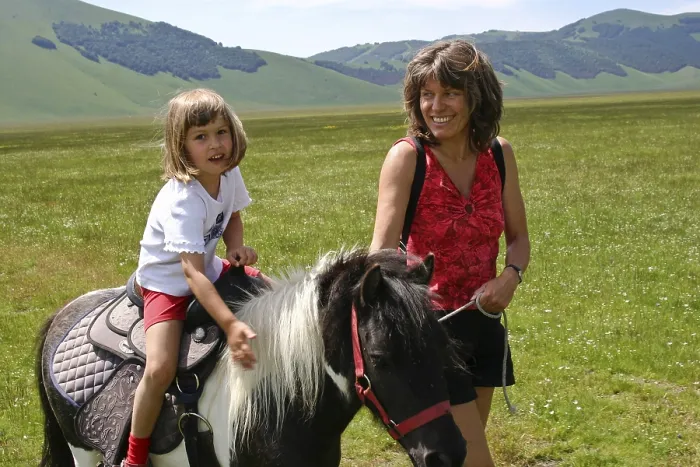 Framed Print : Mother next to daughter riding a pony