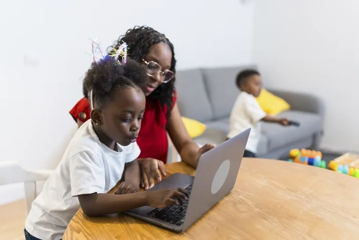 Framed Print : Mother and daughter using laptop computer at home