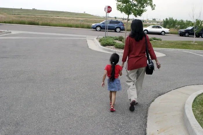 Framed Print : Mother and daughter walking on road