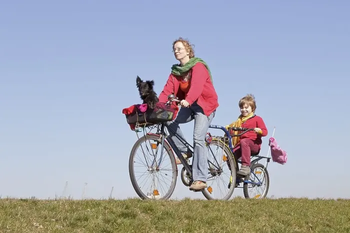 Framed Print : Mother, son and a dog on a bicycle tour