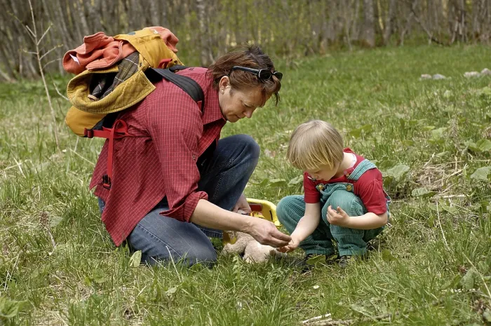 Framed Print : One mother with three-year-old girl examening an insect on a hike