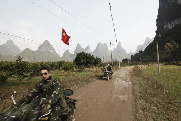 Framed Print : Motorcyclist in front of karst mountains in Yangshuo Framed Print : Motorcyclist in front of karst mountains in Yangshuo