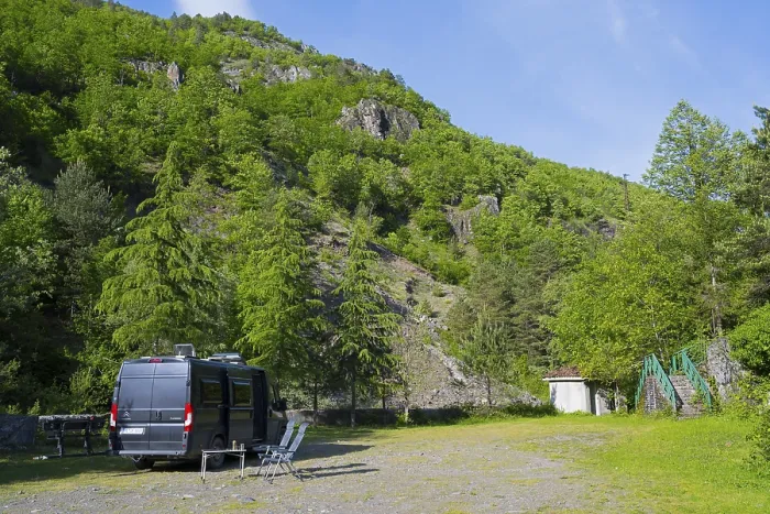 Framed Print : Motorhome is parked on an area in a mountainous and wooded area