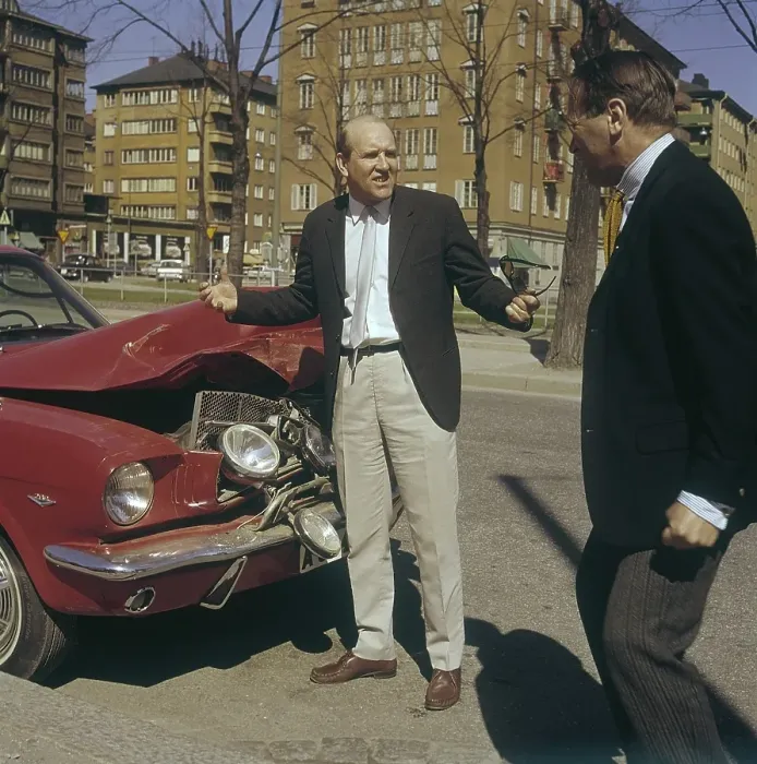 Framed Print : Motoring in the 1960s. A man stands in front of his car that is visibly damaged in a traffic accident Framed Print : Motoring in the 1960s. A man stands in front of his car that is visibly damaged in a traffic accident