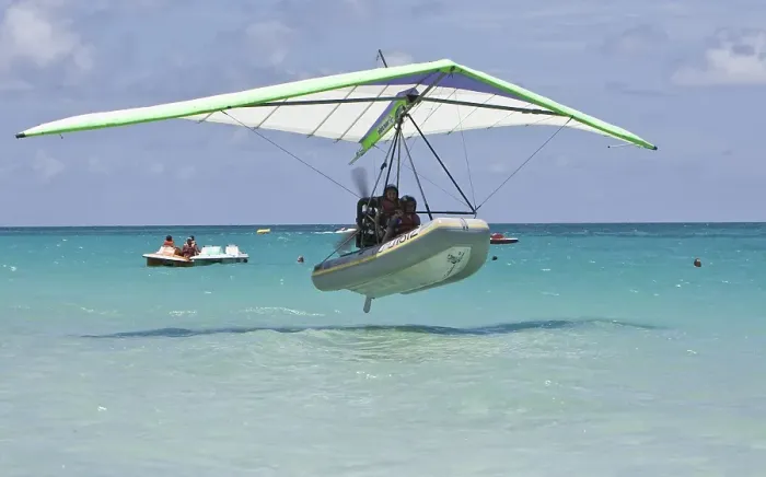 Framed Print : Motorised hang glider landing on the sea