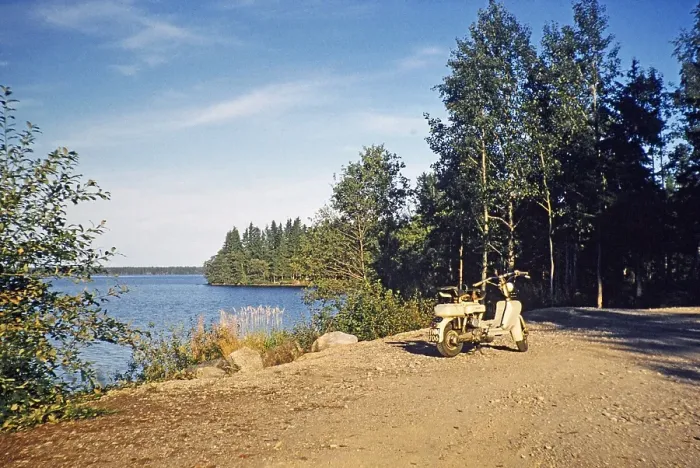 Framed Print : Motorised scooter by a lake in a rural setting, Sweden 1958