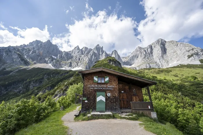 Framed Print : Mountain hut Ackerlhutte, rocky mountain peaks behind Framed Print : Mountain hut Ackerlhutte, rocky mountain peaks behind