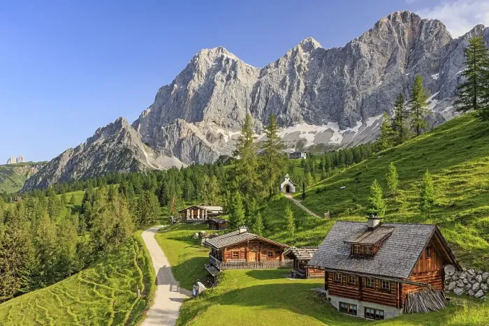 Framed Print : Mountain hut and alp in front of steep mountains in summer