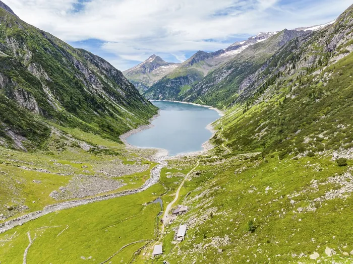 Framed Print : A mountain lake embedded in an alpine landscape with green meadows Framed Print : A mountain lake embedded in an alpine landscape with green meadows