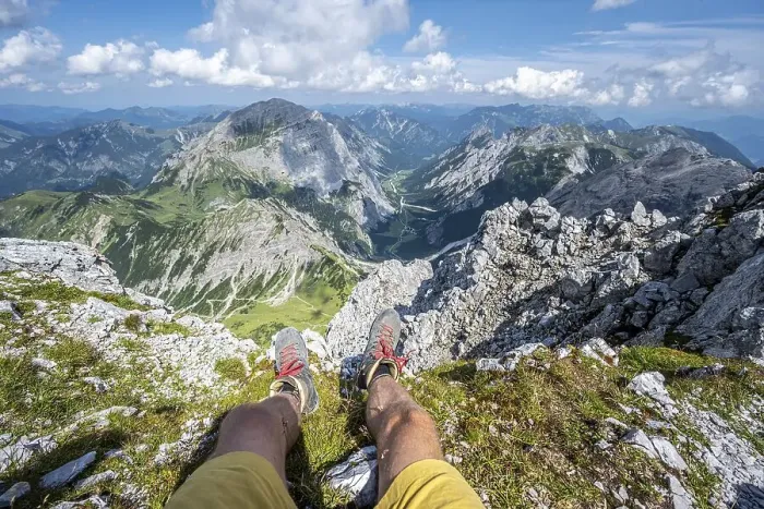 Framed Print : Mountain landscape, hiker lets his legs dangle