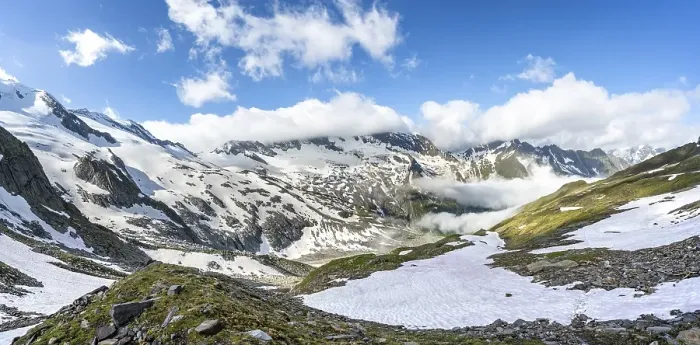 Framed Print : Mountain landscape with snow fields and high fog in the valley